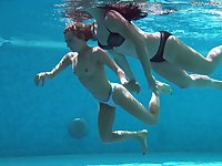 Two bikinis girls get naked in the pool for a swim